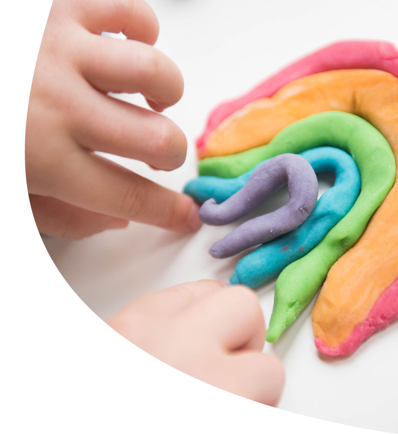 Child molding a rainbow with Play-Doh